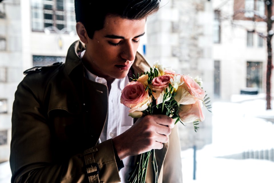 man holding pink roses