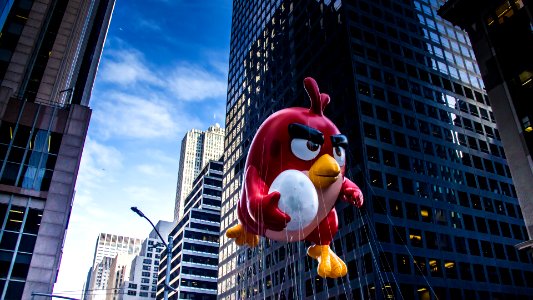 A red angry jumping through the street while holding an egg. photo