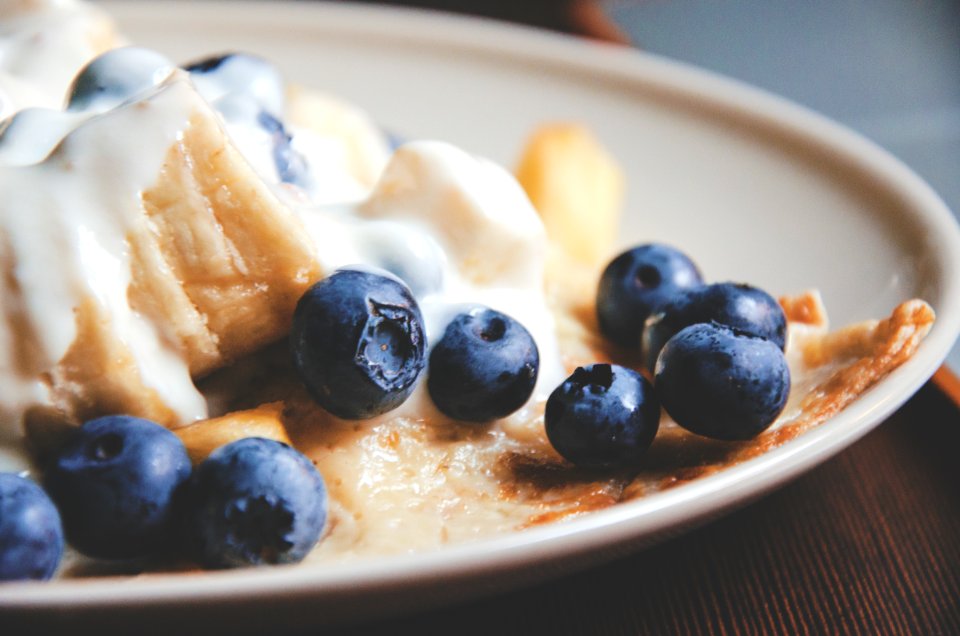 bowl of blue berries with cream photo