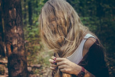woman holding her hair in forest photo
