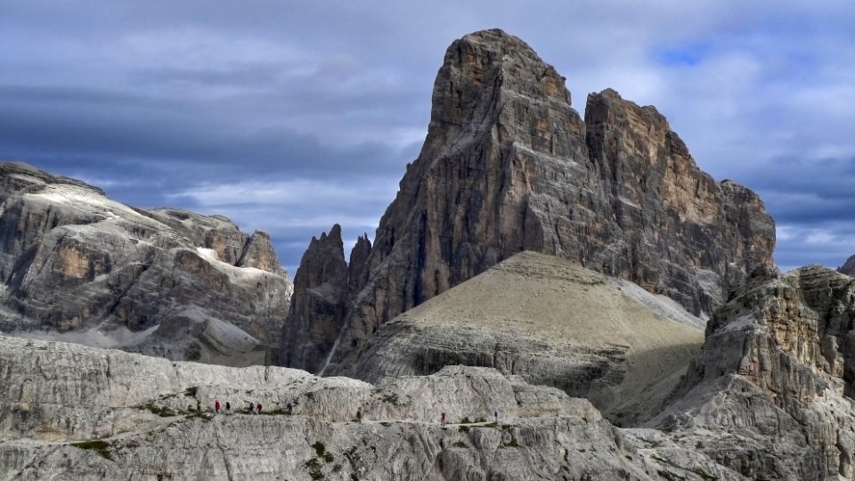 rocky cliff under cloudy sky photo