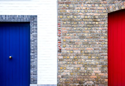 blue wooden door in brick wall photo