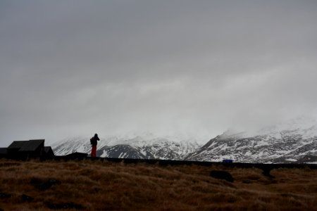 person standing front of mountain photo