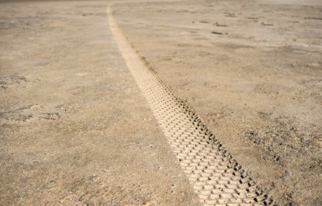 close-up photography of track tire print on ground photo