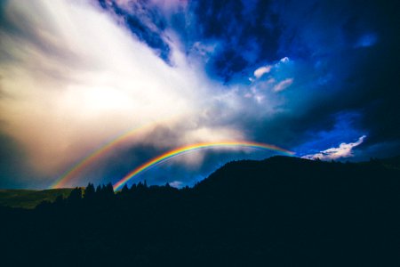 rainbow over mountain illustration photo