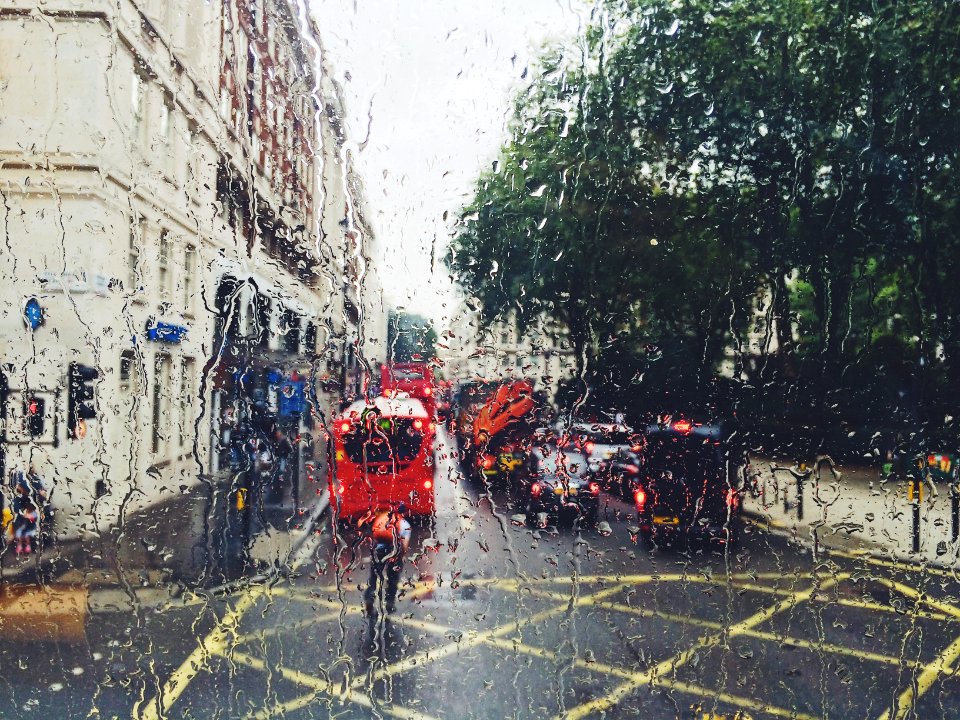 photo of red bus on street from window photo