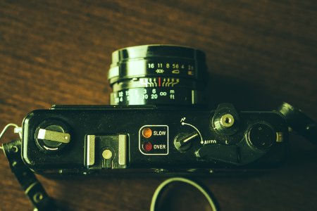 black DSLR camera on wooden surface photo