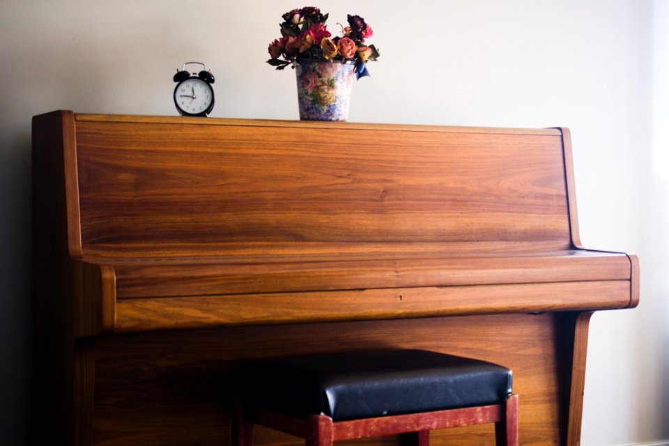 shallow focus photo of brown upright piano