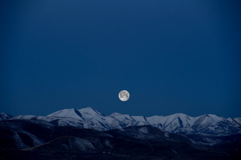 full-moon above snow-capped mountain painting