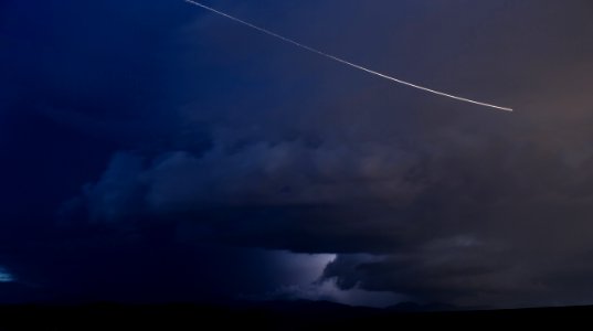 jet flying on sky with dark clouds photo