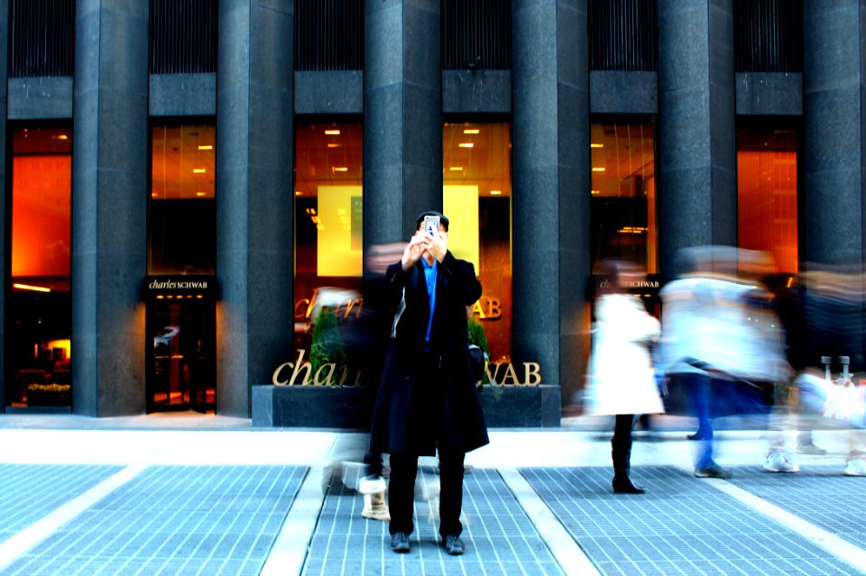 time-lapse photography on man holding phone