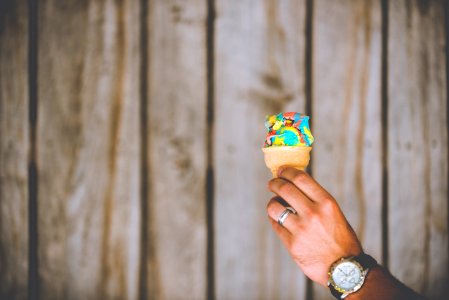 person holding multicolored ice cream photo