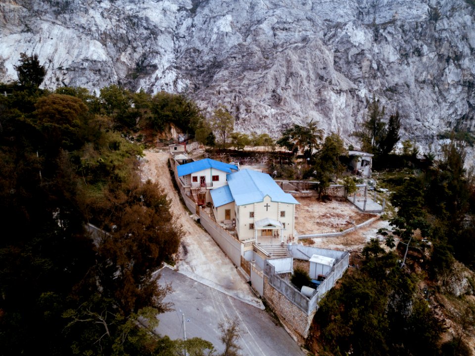 aerial view of church near rock cliff
