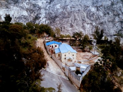 aerial view of church near rock cliff