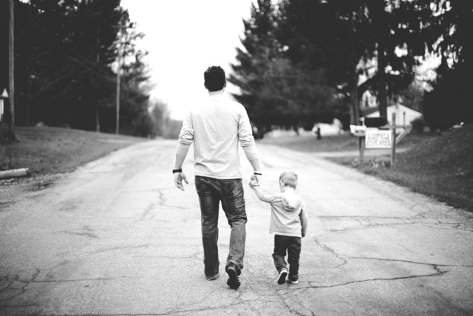 man holding baby's hand