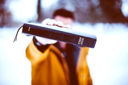 person holding Holy Bible photo