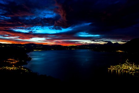 calm body of water near mountain during night time