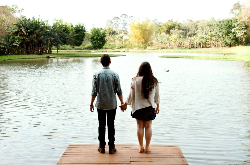 man and woman standing on dock
