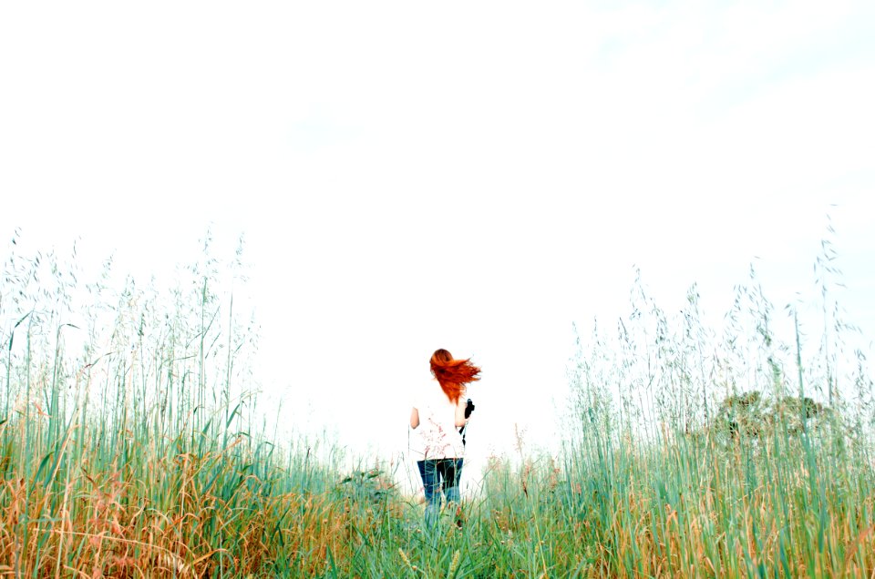 woman standing on green grass field during daytime