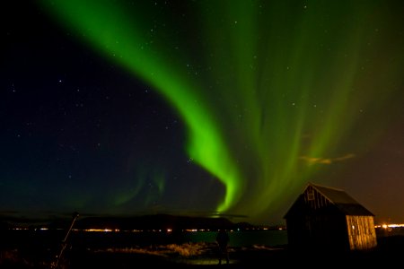 landscape photography of house near body of water with aurora photo