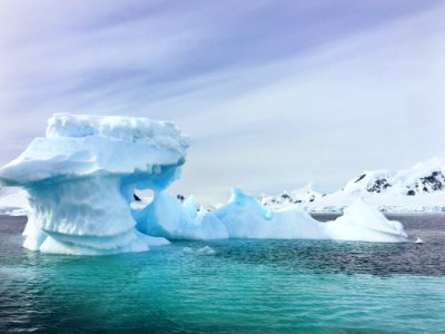 iceberg in middle of ocean photo