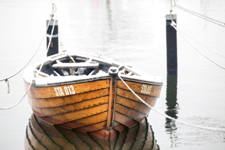 brown wooden boat on body of water
