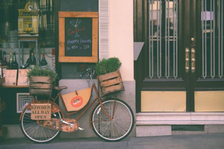 brown city bicycle near brown wooden door photo