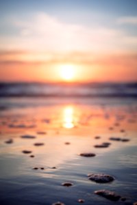 reflection of sunset on beachshore photo