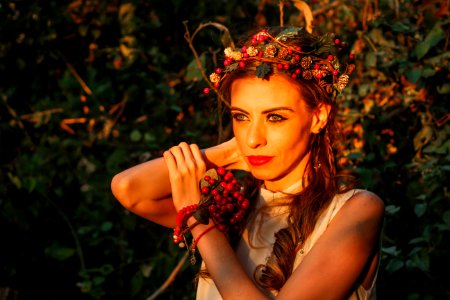 selective focus photography of woman with berry crown on her head