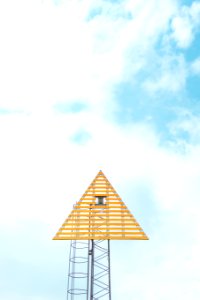 closeup photo of triangle tower with cloudy sky