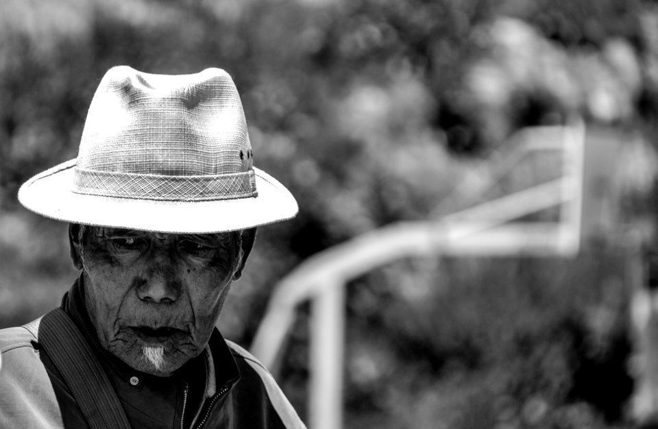 grayscale photo of man wearing hat