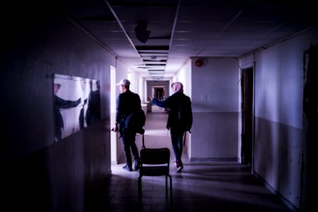 two men walking on corridor