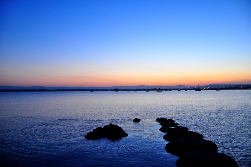 rock formation in water during daytime