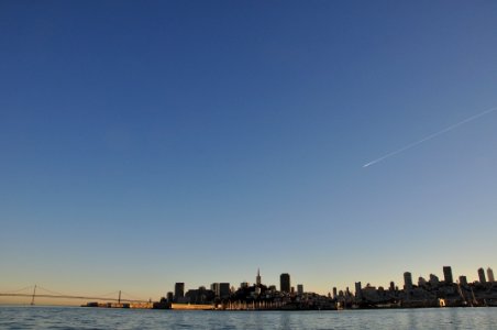 shooting star can be seen through city during daytime photo