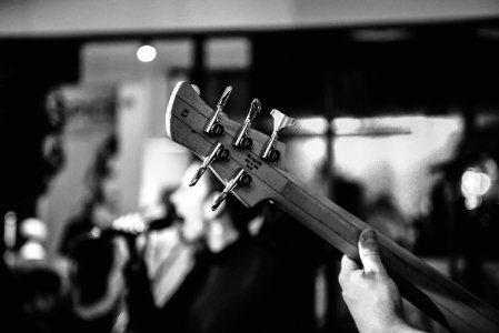 grayscale photo of person playing guitar