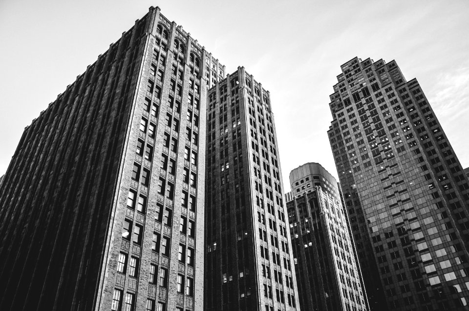 low angle grayscale photography of high-rise buildings photo