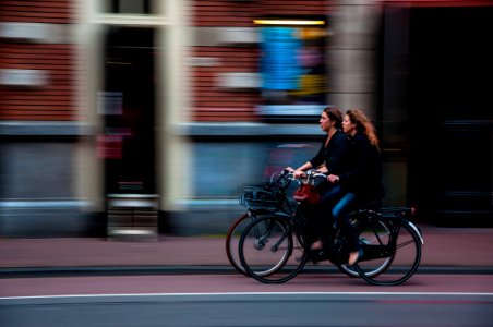 time lapse photography of two person riding bicycle photo