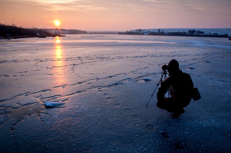 man taking photo of sunset