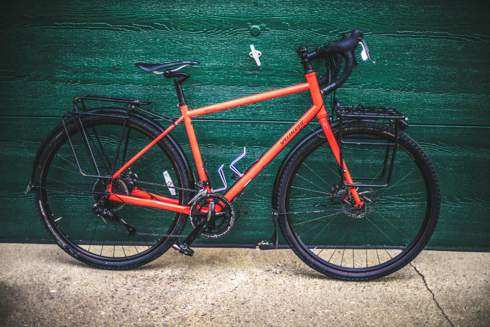 red and black road bike on green wall