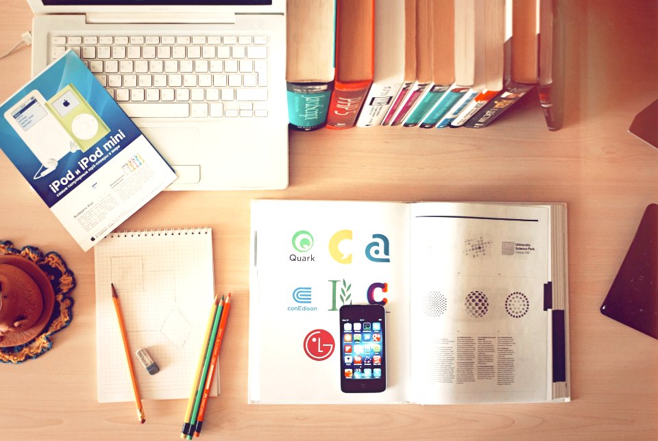 pencils and smartphone on top of books
