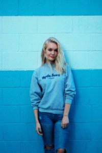 woman in teal sweater and blue jeans photo