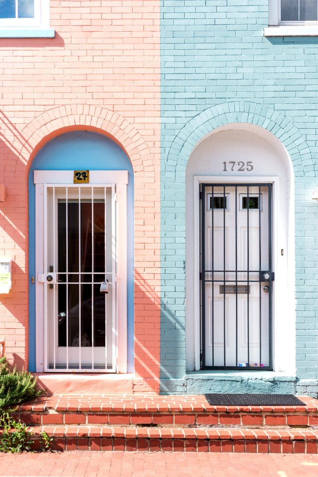two white wooden doors with grills
