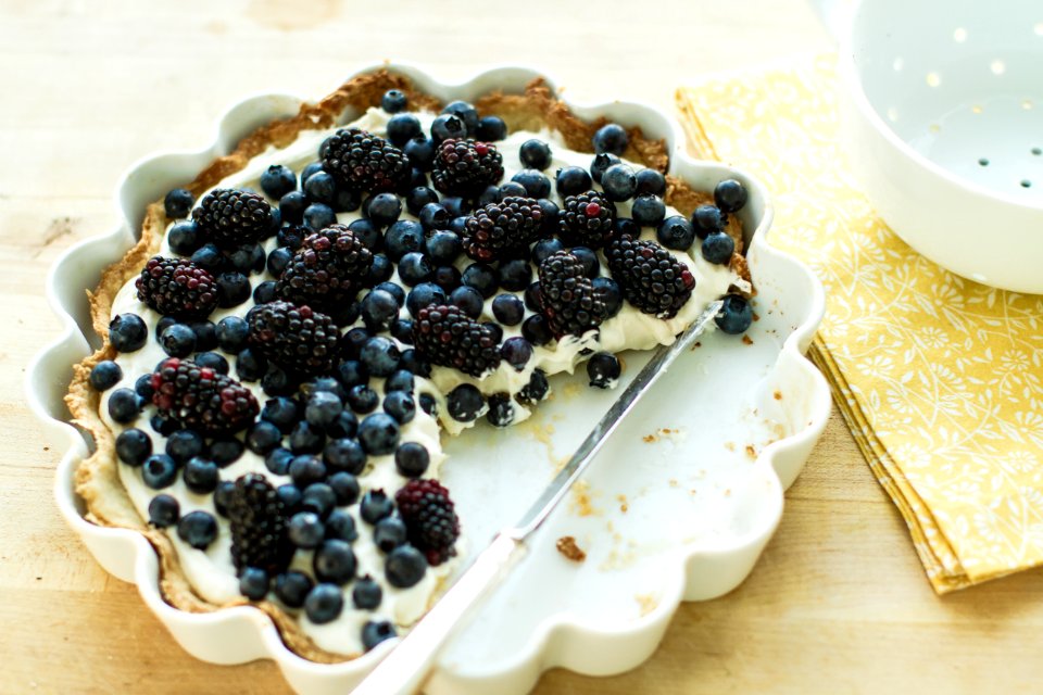 blueberry pie on plate with knife