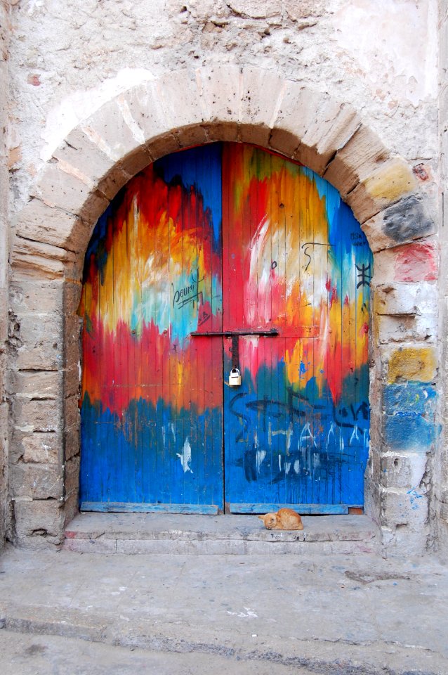 A colorfully painted rounded door.