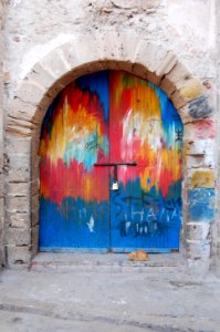 A colorfully painted rounded door.
