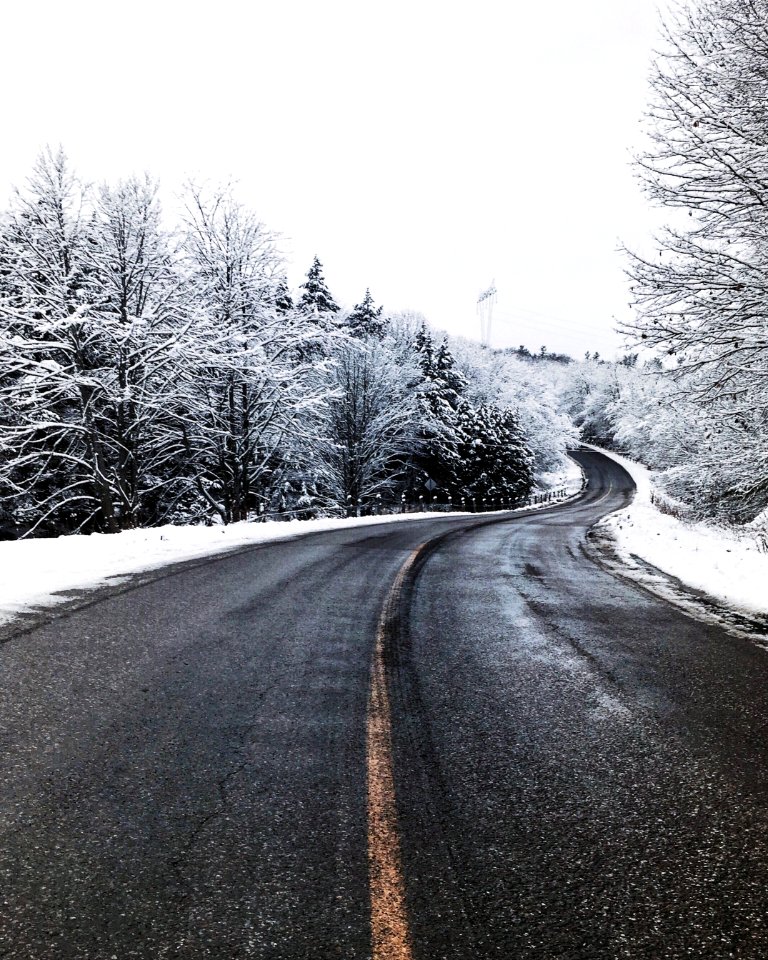 asphalt road in the middle of snow