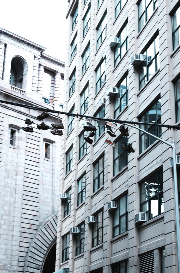 shoes hanging on street pole