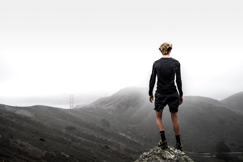 man standing on top of mountain