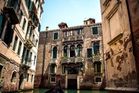 brown concrete building and body of water photo