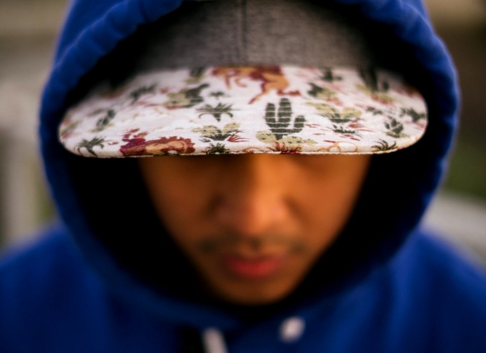 close up photo of white, green, and red floral cap